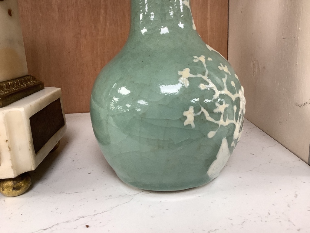 A Chinese celadon bottle vase with white slip decoration, 19th/20th century, height 20cm